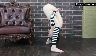 Acrobatic teen with big tits stretching in the leather chair