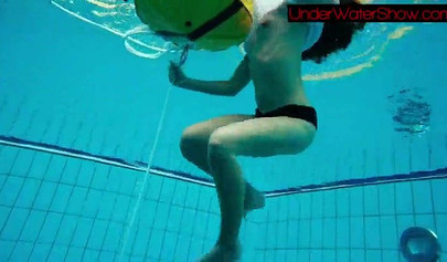 Gorgeous teen strips naked while swimming in the pool