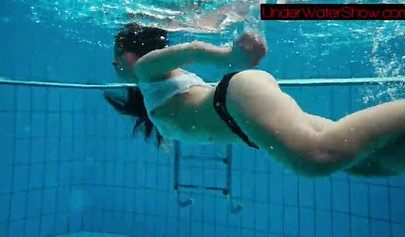 Gorgeous teen strips naked while swimming in the pool