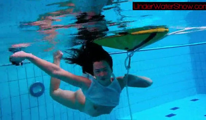 Gorgeous teen strips naked while swimming in the pool