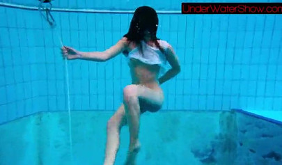 Gorgeous teen strips naked while swimming in the pool