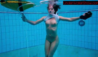 Gorgeous teen strips naked while swimming in the pool