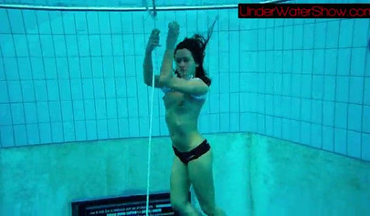 Gorgeous teen strips naked while swimming in the pool