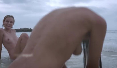 Four petite teens stripping and posing nude on the sandy beach